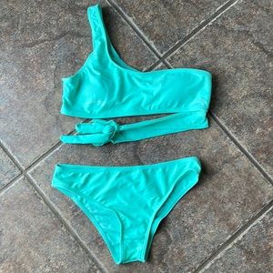 Bikini size medium. Brand new never worn. Still has sanitary liner in bottoms